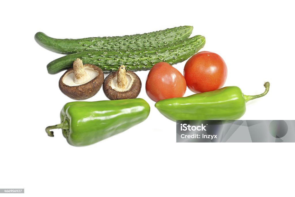 vegetables closeup of vegetables in white background, cucumber, tomato, green peppers and mushrooms Agriculture Stock Photo