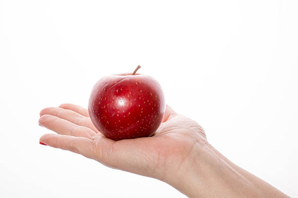 istock Woman's hand with red apple on white background 466956976
