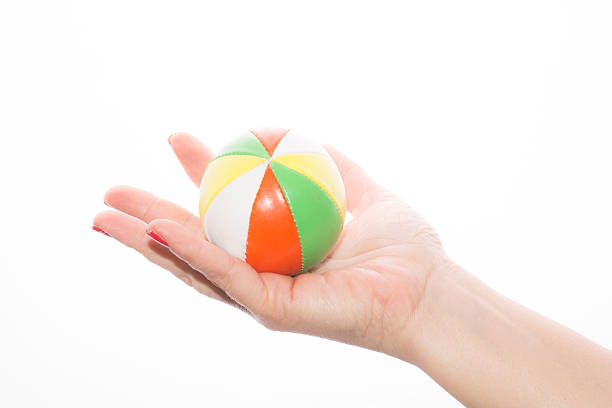 istock female hand holding colored juggling balls on a white background 466956980