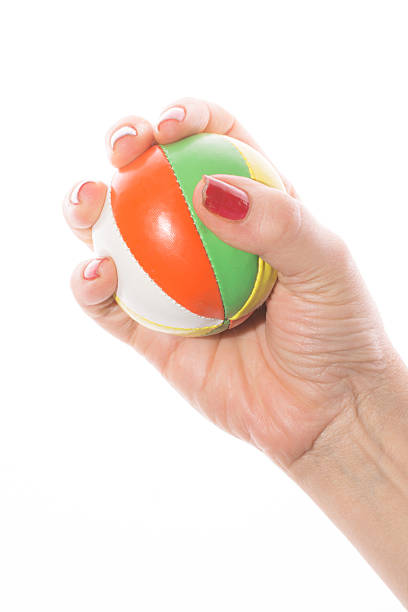 istock female hand grabs colorful juggling balls on a white background 466956982