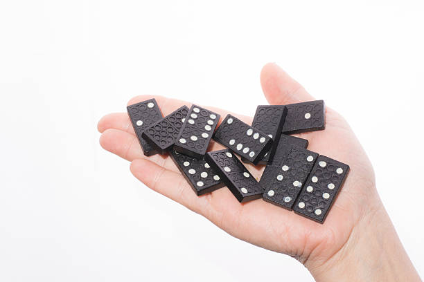 istock Dominoes in female hand on a white background 466958004