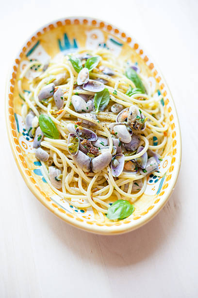 Spaghetti with Clams Spaghetti with clams and zucchini flowers cooked selective focus vertical pasta stock pictures, royalty-free photos & images