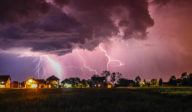 Thunder is Coming II This is a picture of a storm above my village. There was rain and thunder all around me,and above me there was a clear sky full of stars. .It was amazing, so after an hour of shooting i captured this moment. You can see it's raining, and thunder is coming out from the same cloud at the same time. Microburst stock pictures, royalty-free photos & images