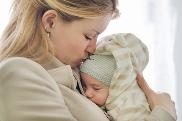 istock Mother kissing a baby 466958518