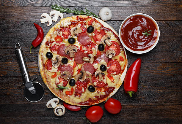 istock Hot pizza with ingredients and cutter 466959017
