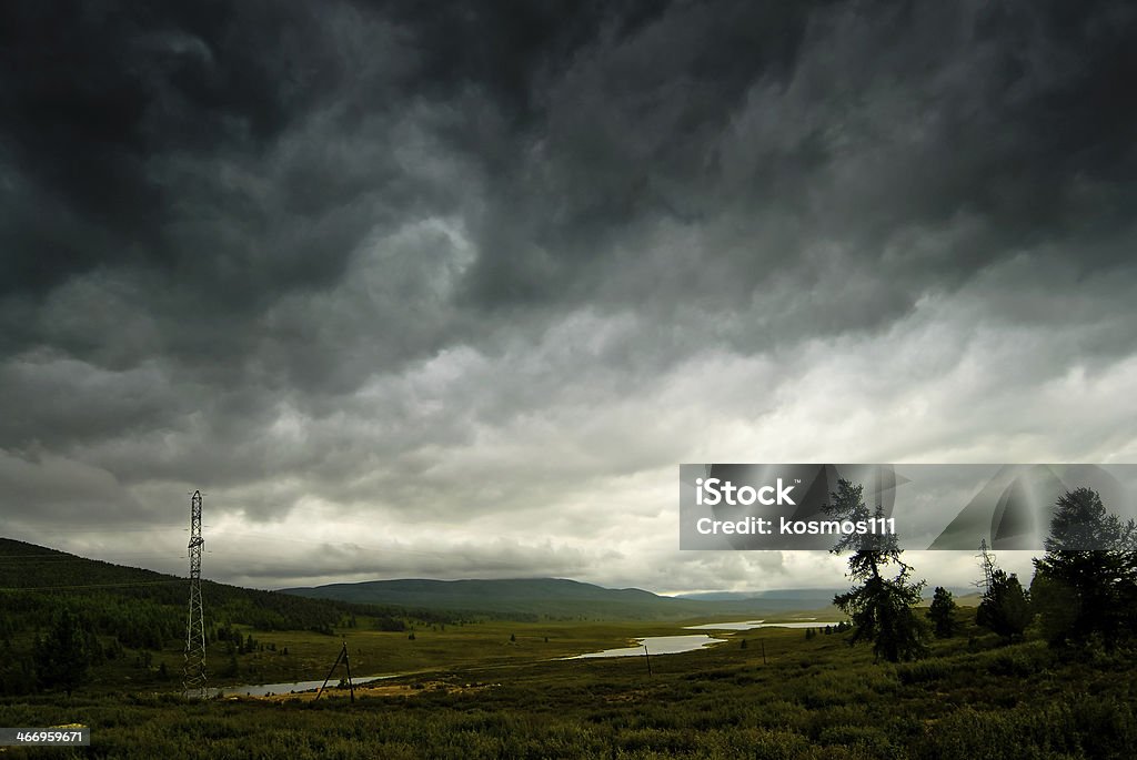 Black stormy sky in the rain mountains. Altai. Black stormy sky in the rain in the mountains. Altai. Russia Altai Nature Reserve Stock Photo