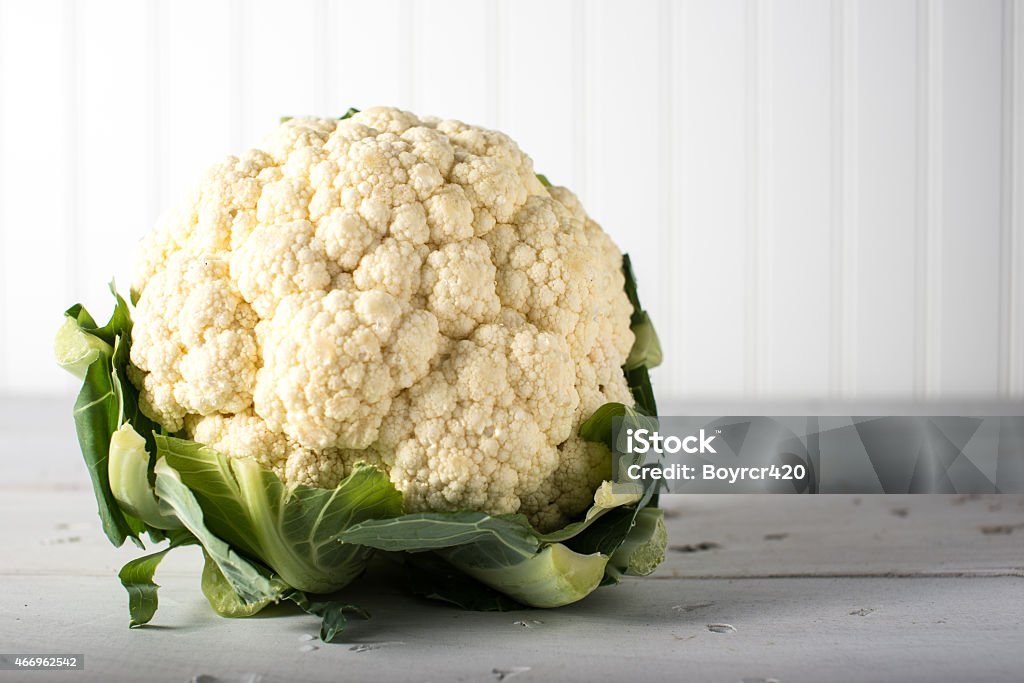 Head of cauliflower on white rustic table head of Cauliflower vegetable on rustic white table 2015 Stock Photo