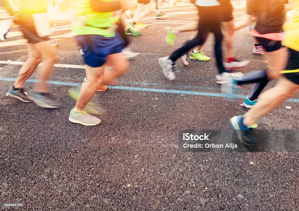 People running Runner legs, outdoors. Logos and distinctive elements have been removed. Blurred Motion Stock Photo