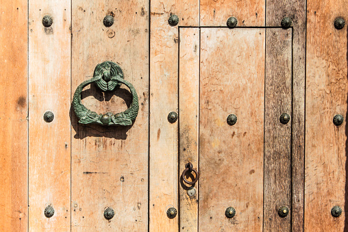 Wooden colonial style door with bronze hasp fish alike