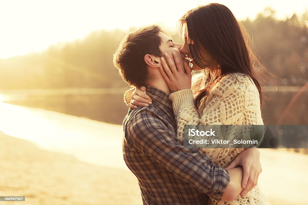 Young couple in love outdoor Kissing Stock Photo