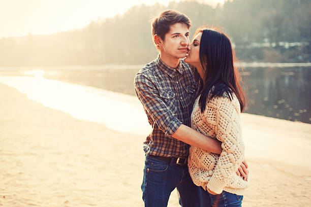 beautiful young couple embracing near the river stock photo
