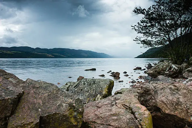 Photo of View of Loch ness Lake in Scotland, cloudy dramatic light