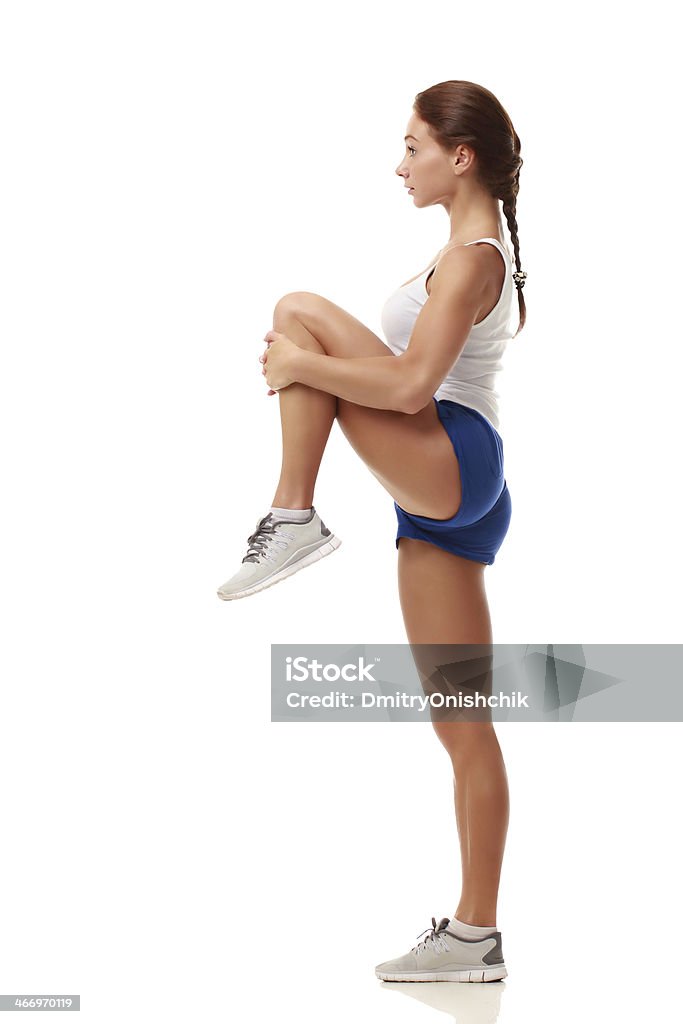Young attractive female fitness model stretching Young attractive female fitness model stretching left knee Exercising Stock Photo
