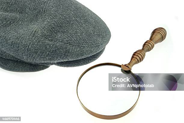 Warm Cap With Earflaps And Magnifying Glass Stock Photo - Download Image Now - 2015, Business, Cap - Hat