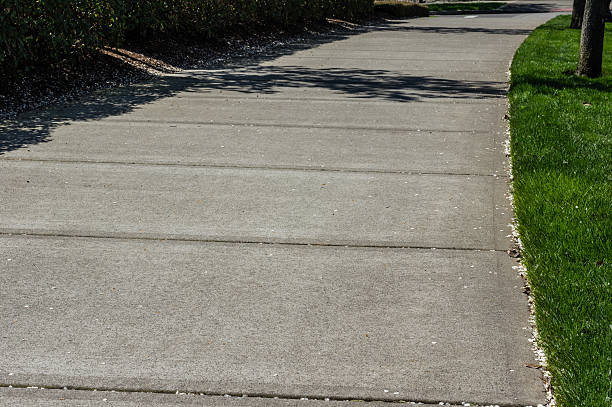 istock Concrete sidewalk in a grassed park 466970528