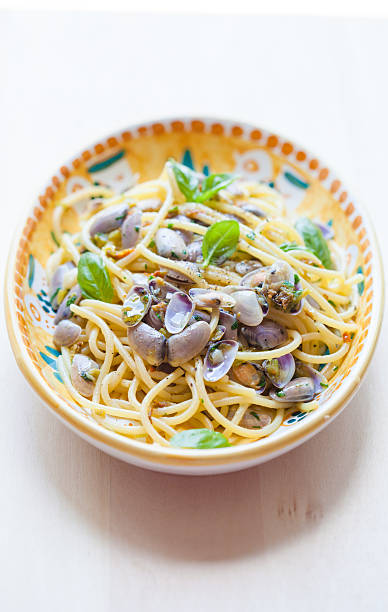 Spaghetti with Clams Spaghetti with clams and zucchini flowers cooked selective focus vertical pasta stock pictures, royalty-free photos & images