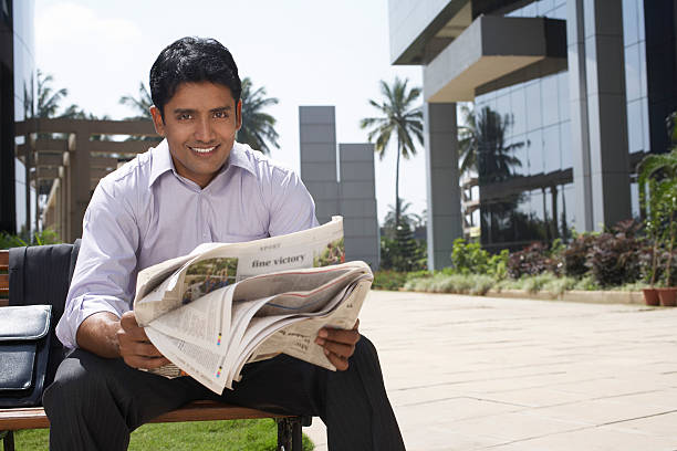 istock Businessman Reading Newspaper Outdoors 466971652