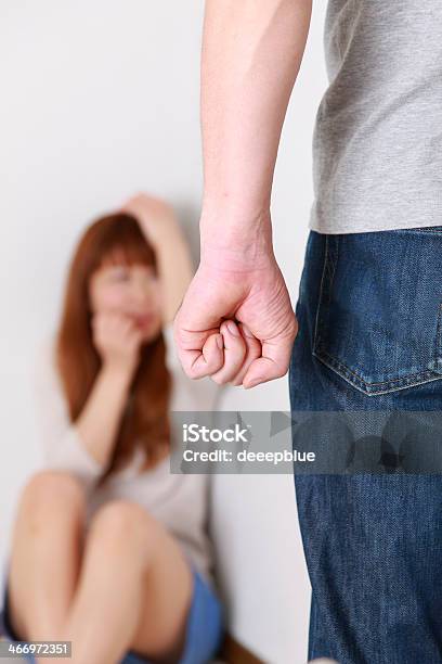 Man With Clenched Fist Walks Towards Woman Stock Photo - Download Image Now - Domestic Violence, Japanese Ethnicity, Women