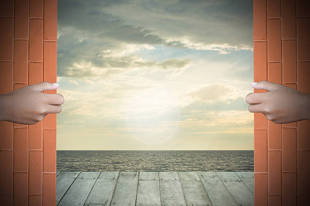 istock Two hands to open the door sea background 466972668