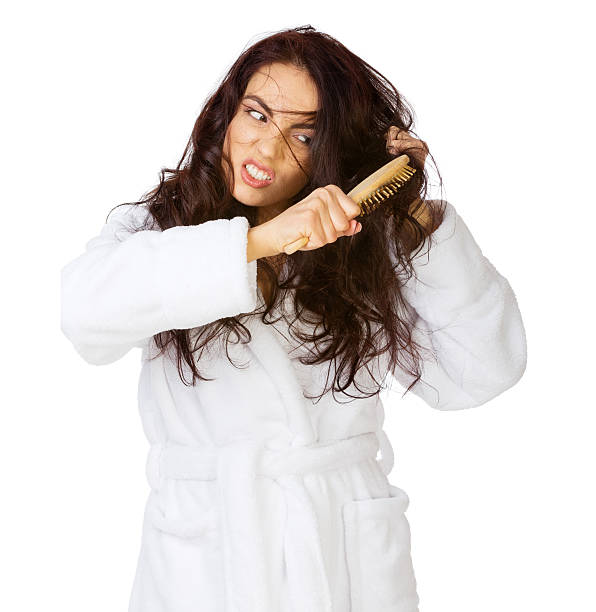 istock Woman struggling with brushing her long hair 466976118