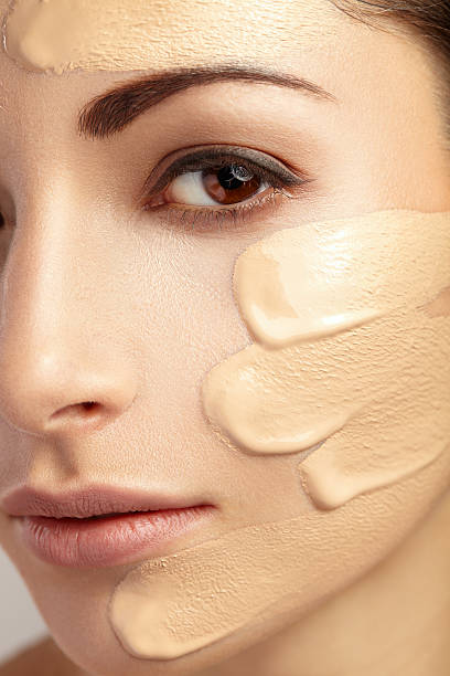 istock Young woman with cosmetic foundation on a skin. 466976408