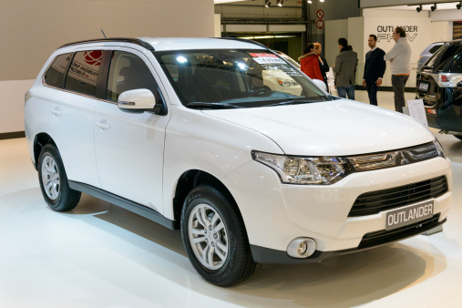 Brussels, Belgium - January 14, 2014: Mitsubishi Outlander crossover SUV on display at the 2014 Brussels motor show. People in the background are looking at the cars.