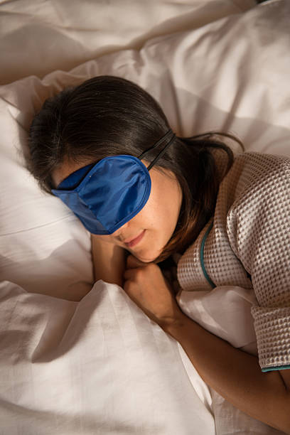 istock girl sleeping on the bed while wearing a blindfold 466978186