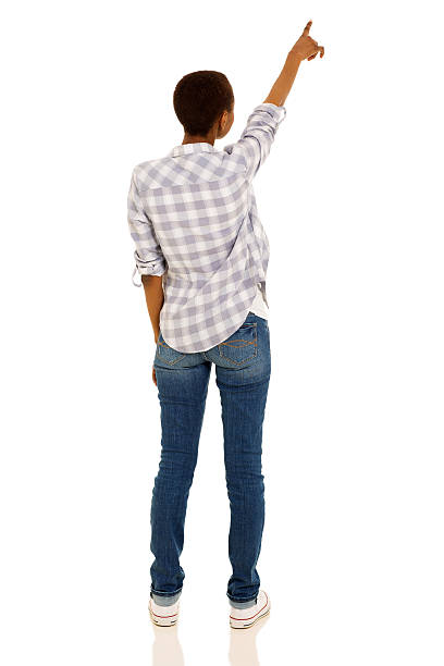back view of young african woman pointing at empty space