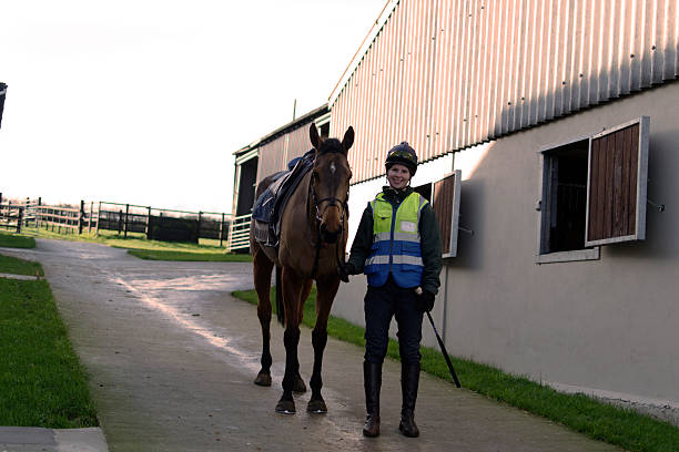 istock Racehorse and stable jockey 466978857