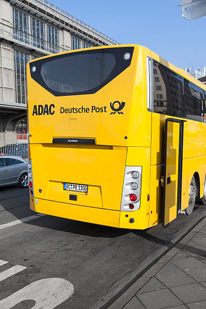 ADAC Postbus Frankfurt, Germany - January 30, 2014: Backside of ADAC Postbus in the city center of Frankfurt, waiting for passengers. ADAC Postbus is an Intercity bus service of Deutsche Post Mobility and German automobile association ADAC. It operates after the deregulation of the German Fernbusverkehr (intercity bus connections) various routes through Germany. adac stock pictures, royalty-free photos & images