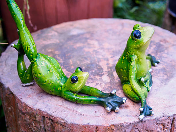 istock Frog figurine as yoga pose decorative in garden 466980982