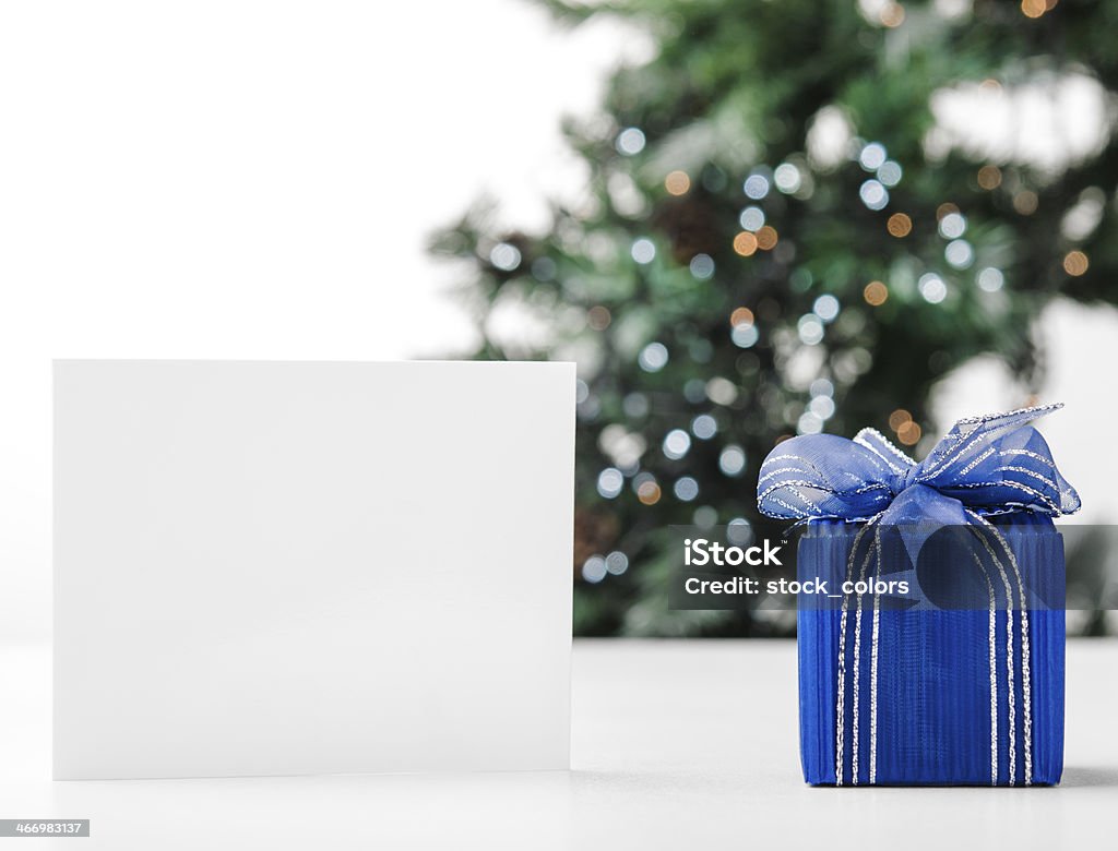 Christmas gift Christmas blue gift and empty card near it. Birthday Stock Photo