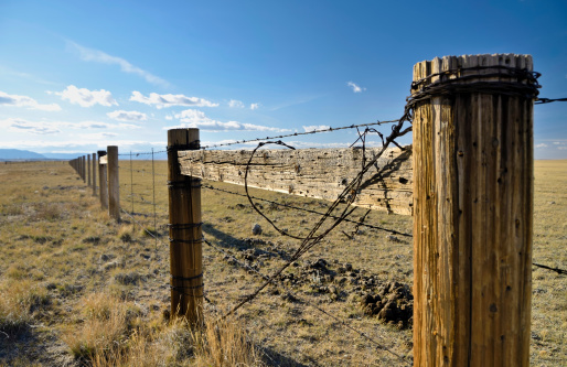 A fence in the rugged landscape of Wyoming. Taken near the Snowy Range outside of Laramie.