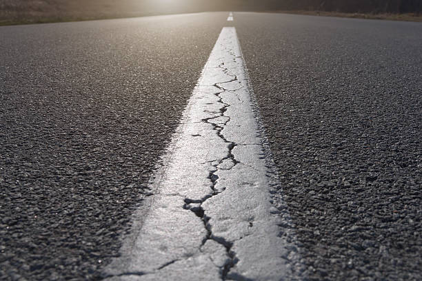 istock Straight line on asphalt full of cracks 466986164