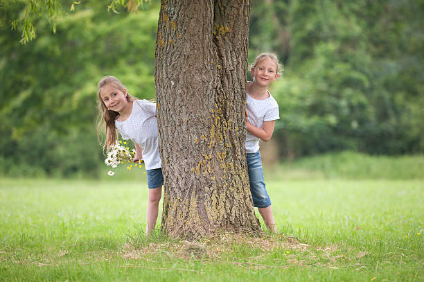 istock little girls playing hide and seek 466986761