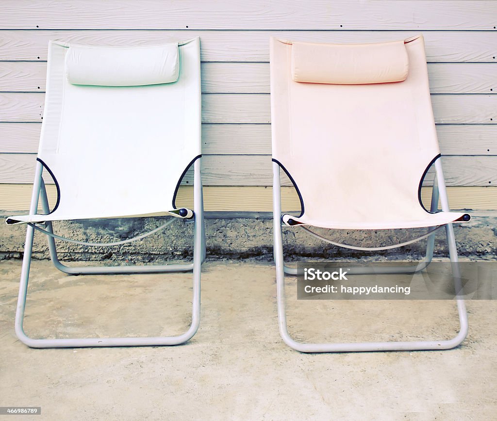 Two beach bench in front of the house Two beach bench in front of the house with retro filter effect Auto Post Production Filter Stock Photo