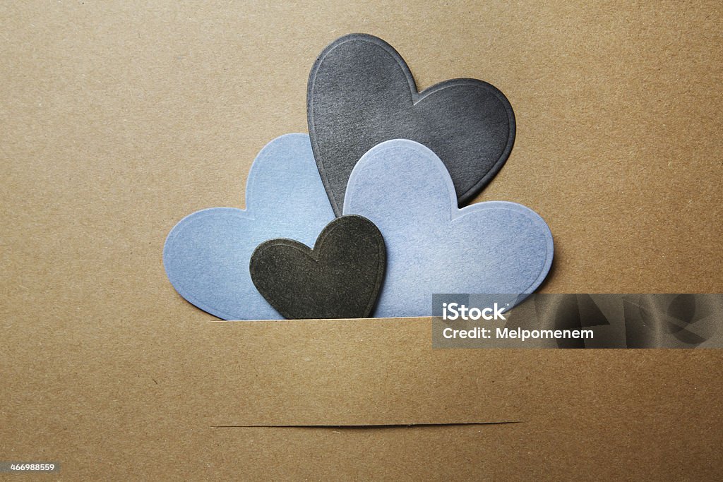 Paper cut blue and black hearts Paper cut blue and black hearts on earthy colored paper Art And Craft Stock Photo