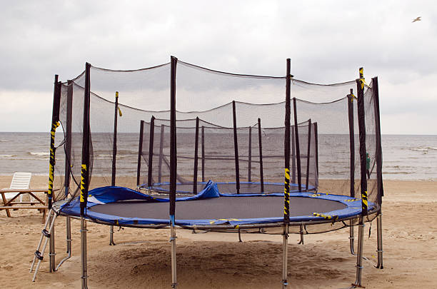 Trampolines on beach sea sand. Active recreation.