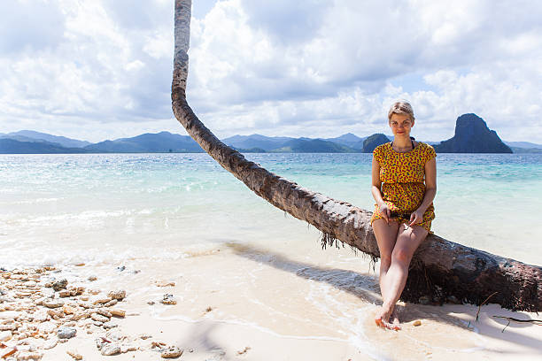 istock Woman sitting on a palm 466991607