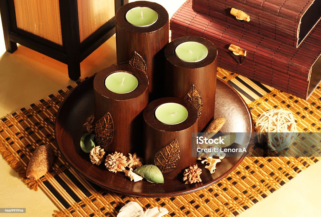 Candles decorative Composition of four decorative candlesticks in the Japanese style on a background of bamboo caskets 2015 Stock Photo