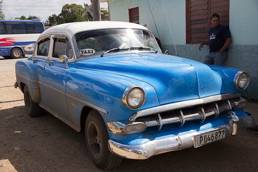 Trinidad, Cuba - February 7, 2015: Blue and white taxi, vintage Chevrolet . Many classic American cars survived in Cuba and are essentially taxis, great tourist attraction . Taken in Valley de los Ingenios