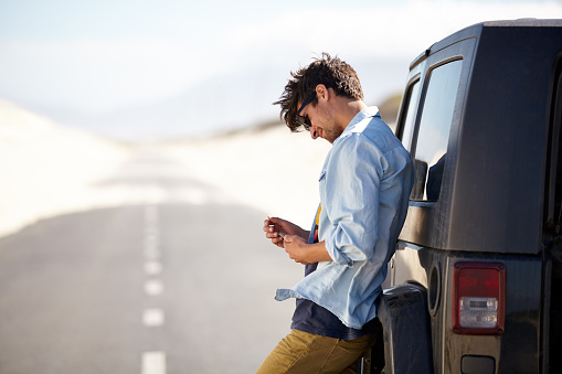A young man phoning for roadside assistancehttp://195.154.178.81/DATA/istock_collage/0/shoots/780937.jpg