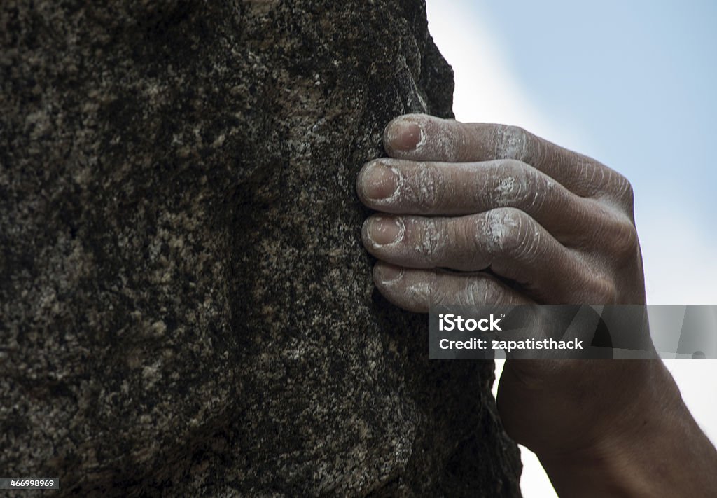 Climber's hand grip Climber gripping a granite boulder of rock Adult Stock Photo