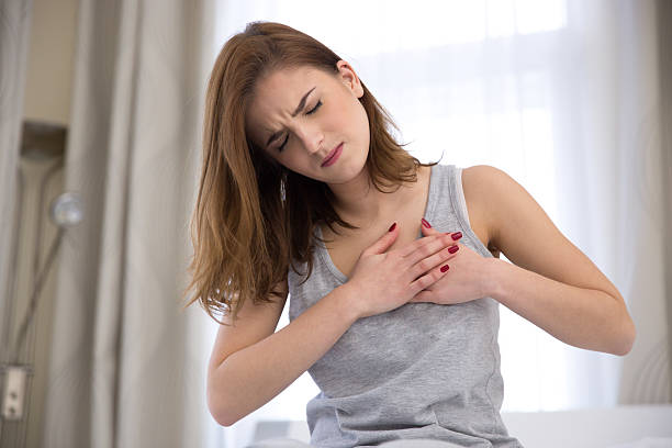 istock woman in pajamas having heart attack 466999732
