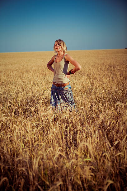 istock young woman on wheat field 467002817