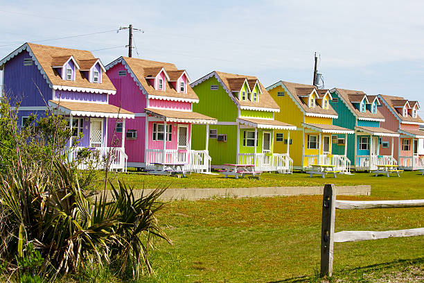 Cheerful Vacation Cabins Multi-colored rental cabins on Cape Hatteras, Outer Banks, North Carolina cape hatteras stock pictures, royalty-free photos & images