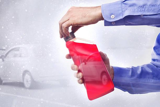 Hand Holding a Bottle of Antifreeze