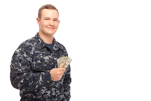 istock Young man in navy uniform with money 467003550