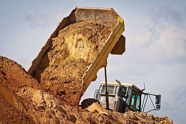 istock Dump truck unloads the sand at construction site 467003735