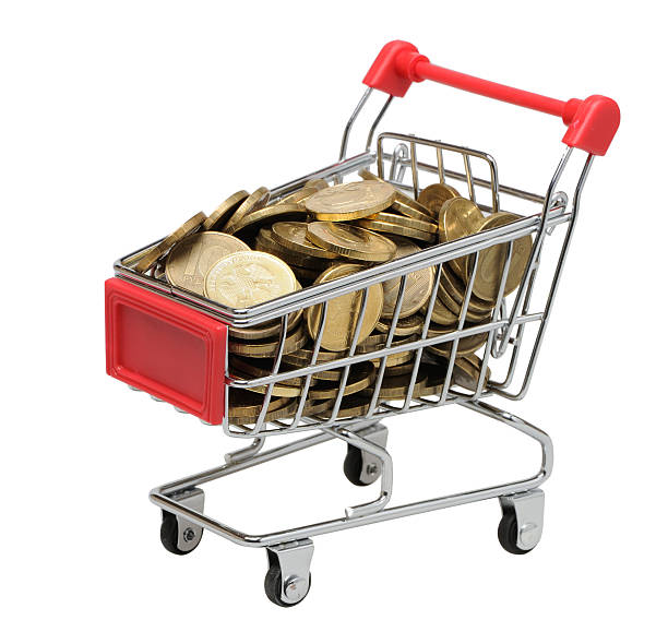 Cart with coins on a white background stock photo